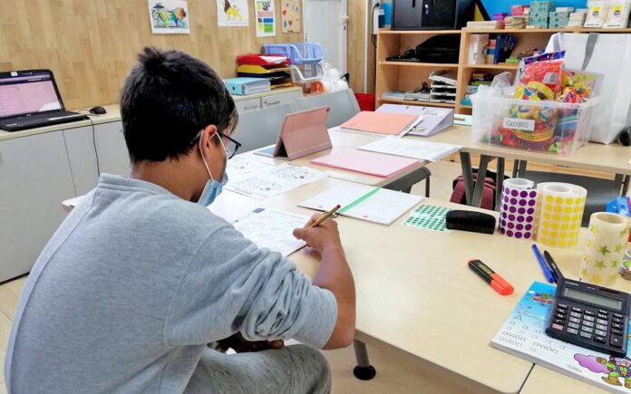 Un niño realiza su tarea en el Aula Escolar del HUC.